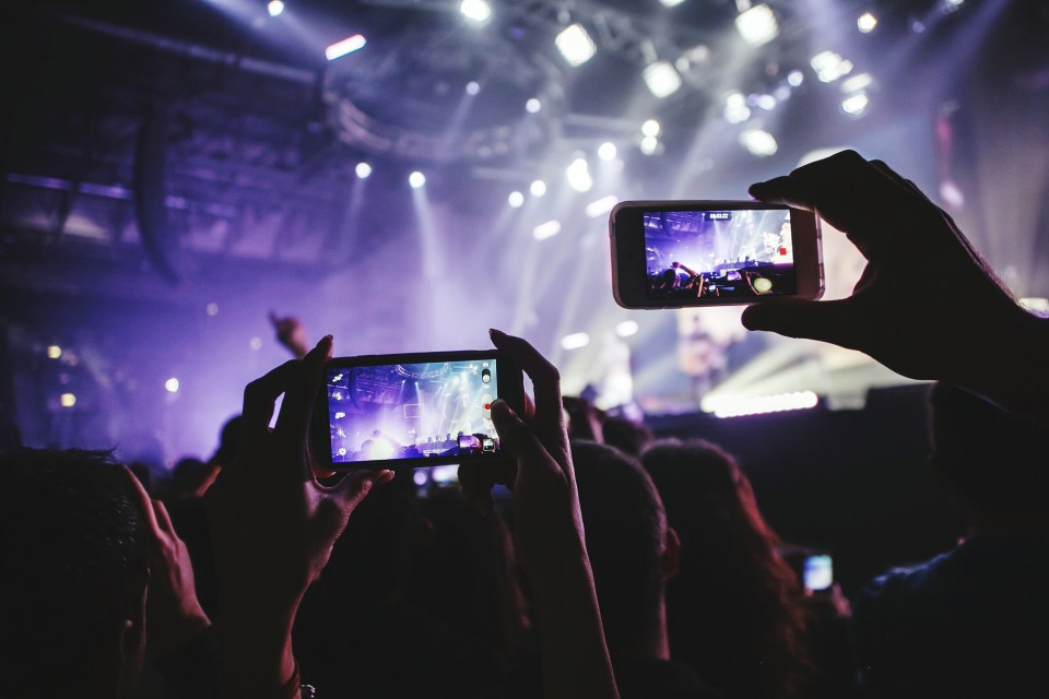  Annoying or liberating? ... Fans using their phones at gigs can annoy some artists