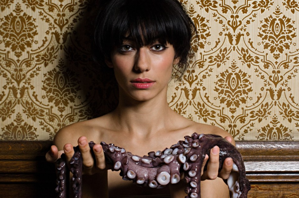 Woman holding a dead octopus