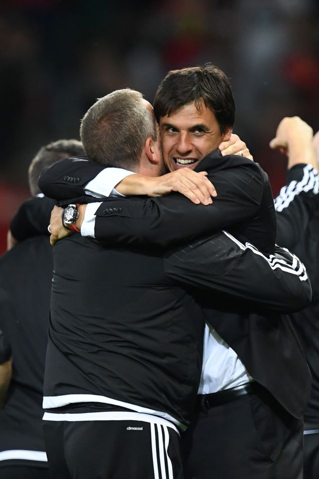  Chris Coleman celebrates the win over Belgium with members of his staff