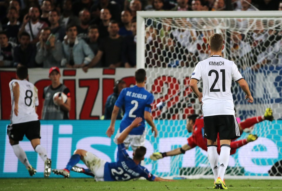 BORDEAUX, FRANCE - JULY 2, 2016: Germany's Joshua Kimmich (21) looks on as his teammate Mesut Ozil (8) scores a goal past Italy's goalkeeper Gianluigi Buffon (1, R back) in their 2016 UEFA European Football Championship quarterfinal match at Stade de Bordeaux. Centre back: Italy's Mattia De Sciglio (2), Emanuele Giaccherini (23). Alexander Demianchuk/TASS (Photo by Alexander DemianchukTASS via Getty Images)