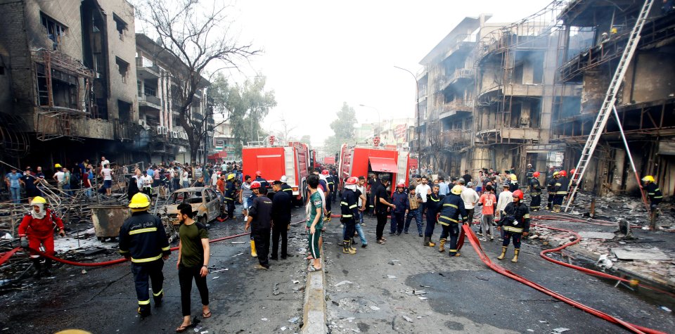  Locals and emergency services gather at the scene of the bombing this morning