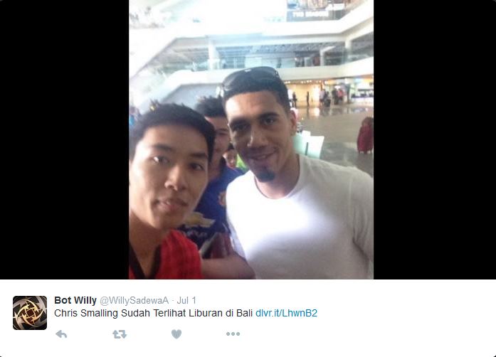 Chris Smalling poses for pictures with supporters in Bali