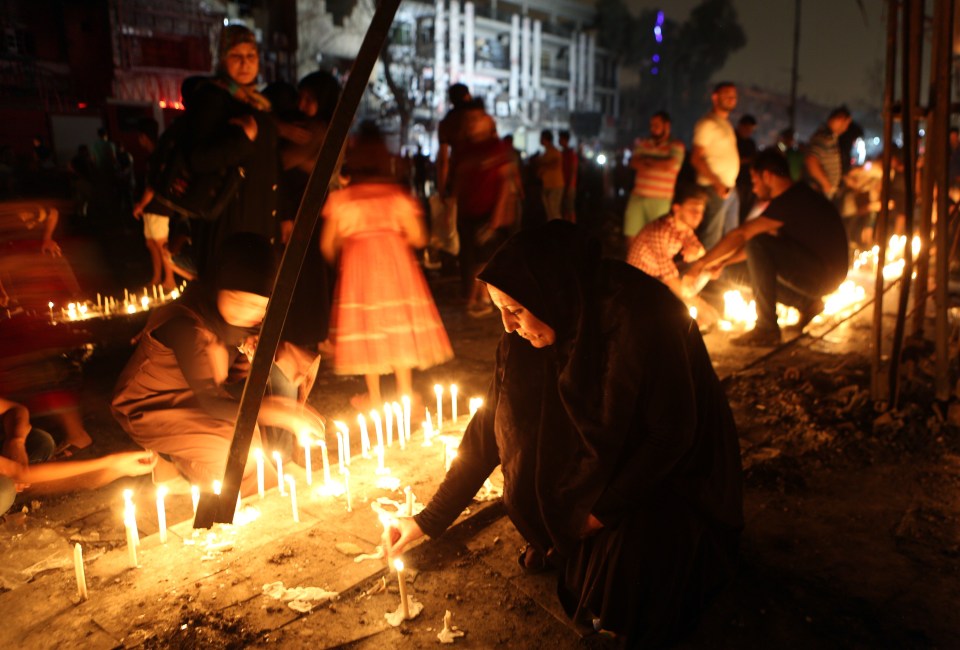  People light candles in remembrance of those killed in the attack