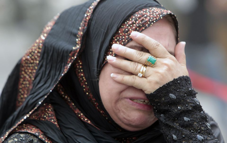  A woman whose apartment was destroyed cries in the street