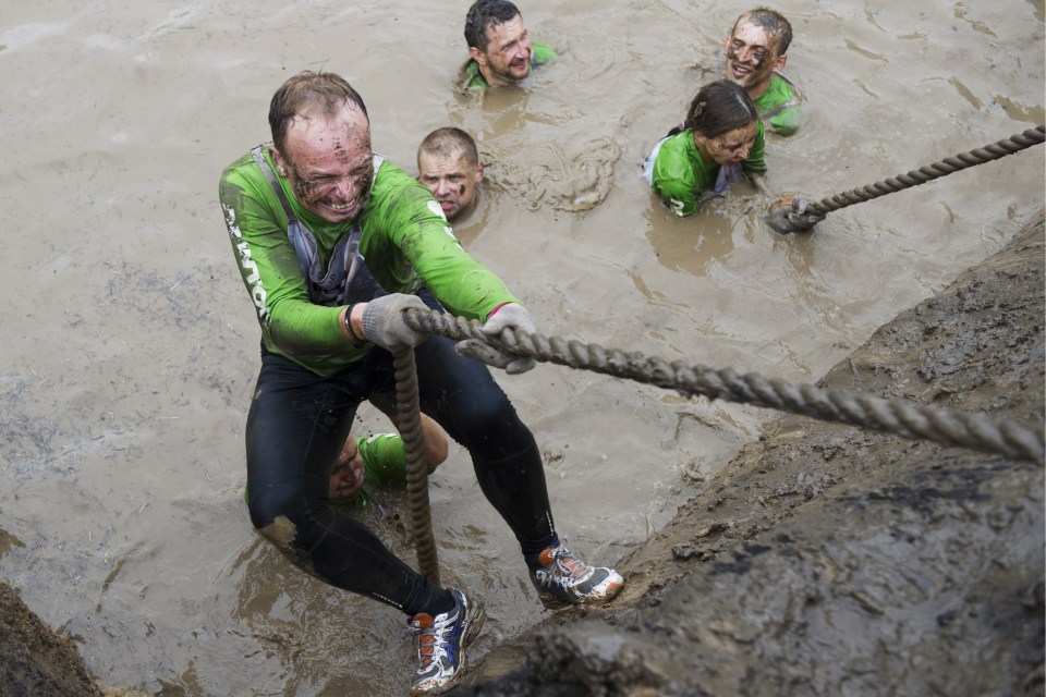 Filthy runners had to use slippery ropes to scale ever-higher walls on the way to finish line