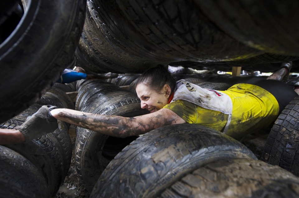 One section forces challengers to crawl through tightly-wedged racks of car tires