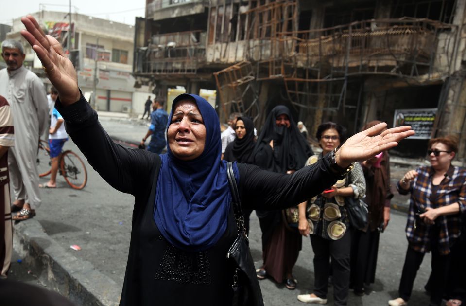  A woman cries as she struggles to come to terms with the senseless killing