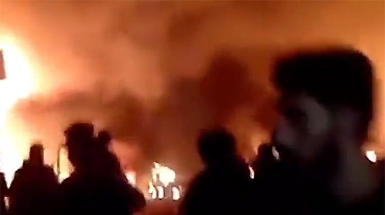  People watch in horror as the fire rips through the buildings with helpless victims trapped inside