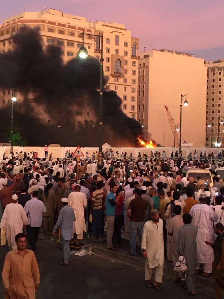 Muslim worshippers gather after a suicide bomber detonated a device near the security headquarters of the Prophet's Mosque in Medina