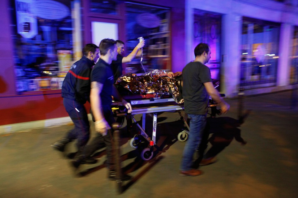  A victim on a drip is wheeled out of the Bataclan