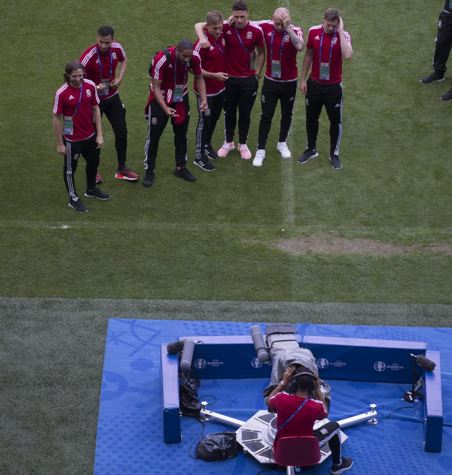  The players pose in front of the camera as Neil Taylor operates it