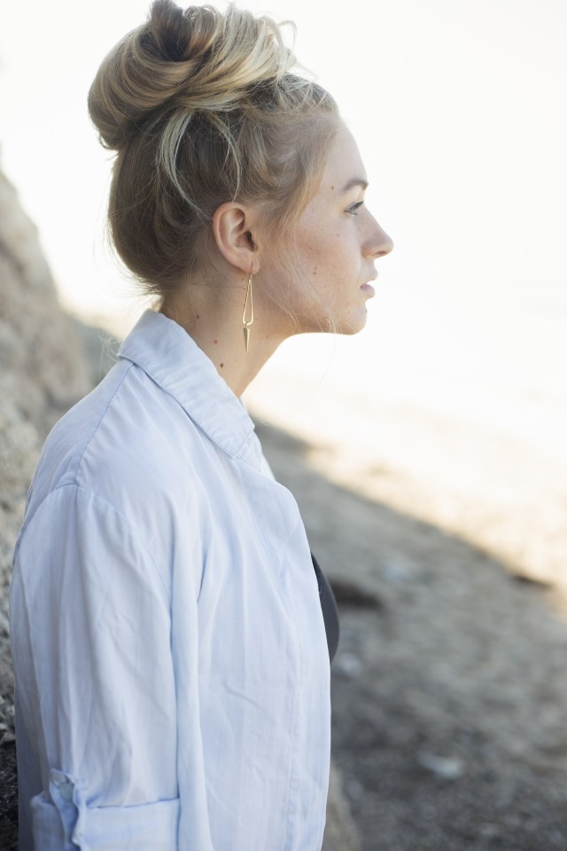 Profile portrait of a blond woman with a hair bun.