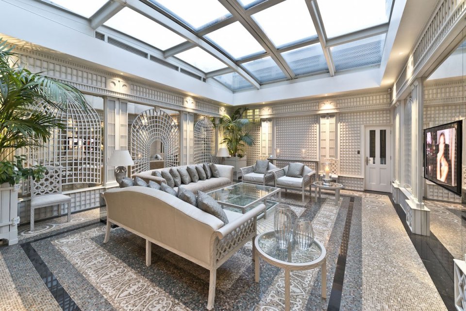 A winter garden offers a airy and open space to relax, with a retractable glass roof opening the property up even more