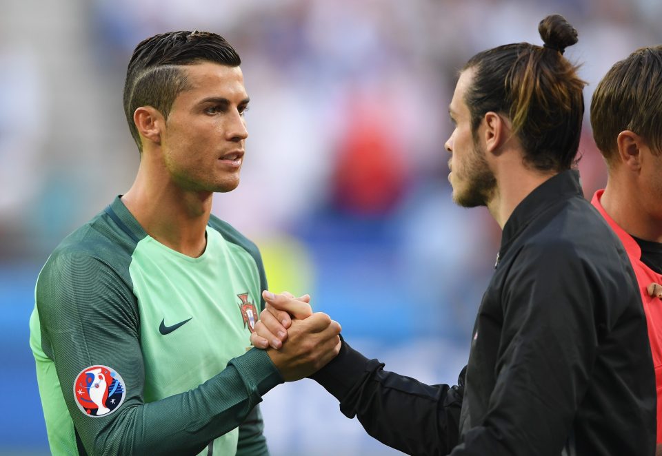  Real Madrid team-mates Cristiano Ronaldo and Gareth Bale shake hands ahead of their Euro 2016 semi final