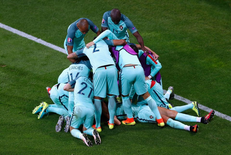  Portugal players mob each other after Ronaldo scores the opener in Lyon