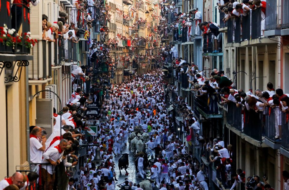  Four people were injured in the crowd of thousands who tried to outrun furious bulls in the streets of northern Spain