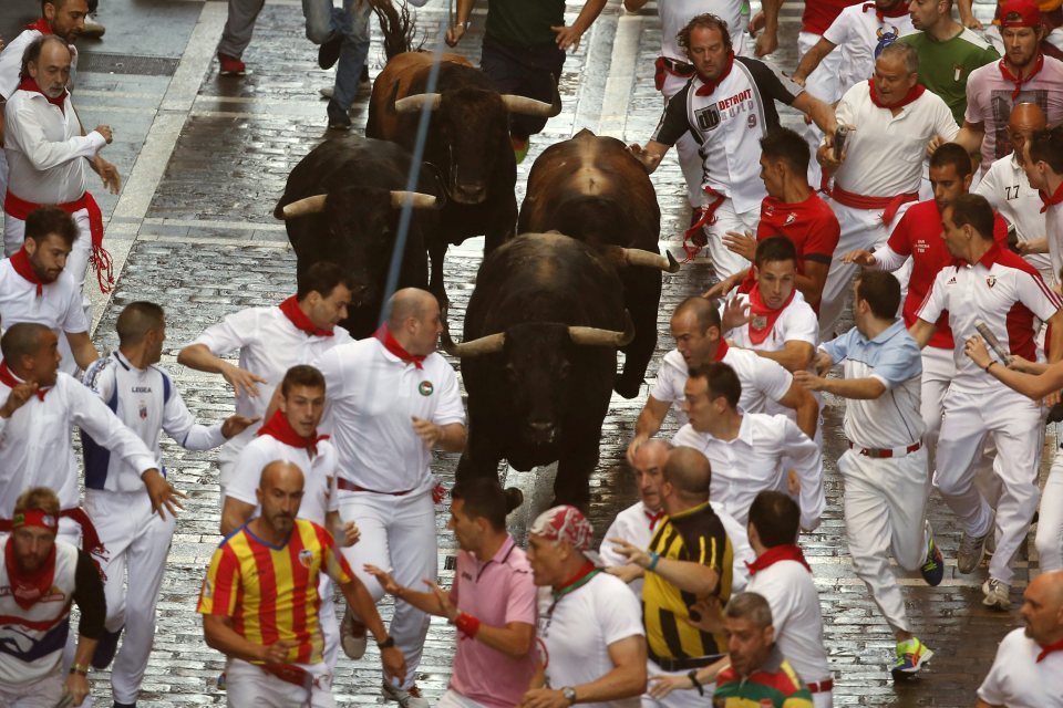  Thousands of thrill-seekers ran with the bulls through Pamplona, with one tactic to try to stay as close to the bull as possible