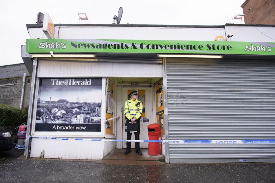  Police guard the newsagent where Mr Shah was stabbed to death