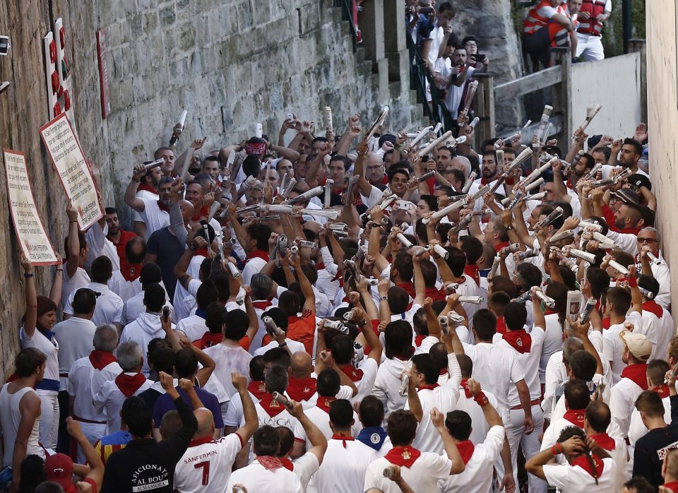  Runners perform the traditional song to St Fermin, hoping for protection, before the annual race begins