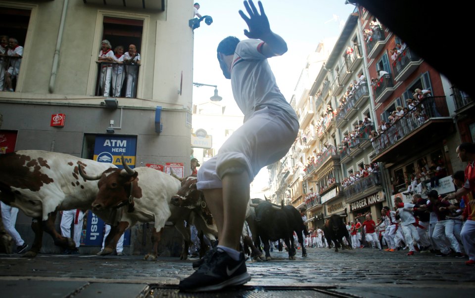  One runner tries to take cover from the charging bulls. In all, 15 people have died from gorings in the San Fermin festival since record-keeping began in 1924