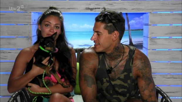 Emma cuddles a puppy with Terry on Love Island