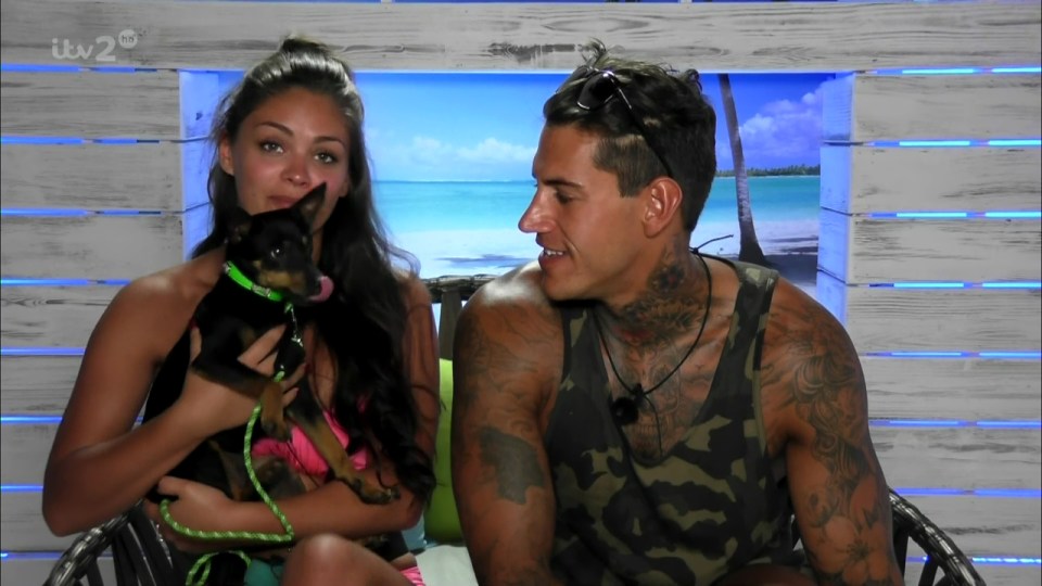  Emma cuddles a puppy with Terry on Love Island