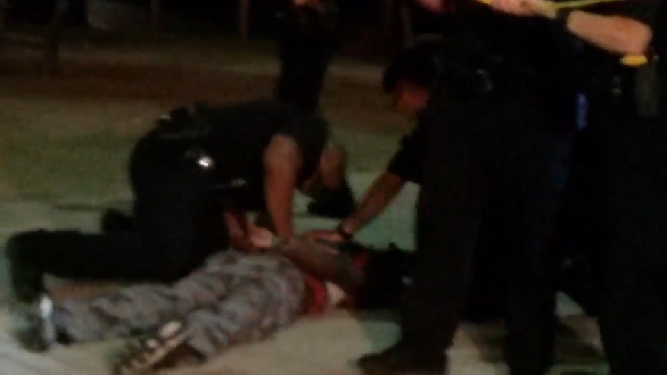 The man is held to the ground and arrested as witnesses yell 'don't shoot'