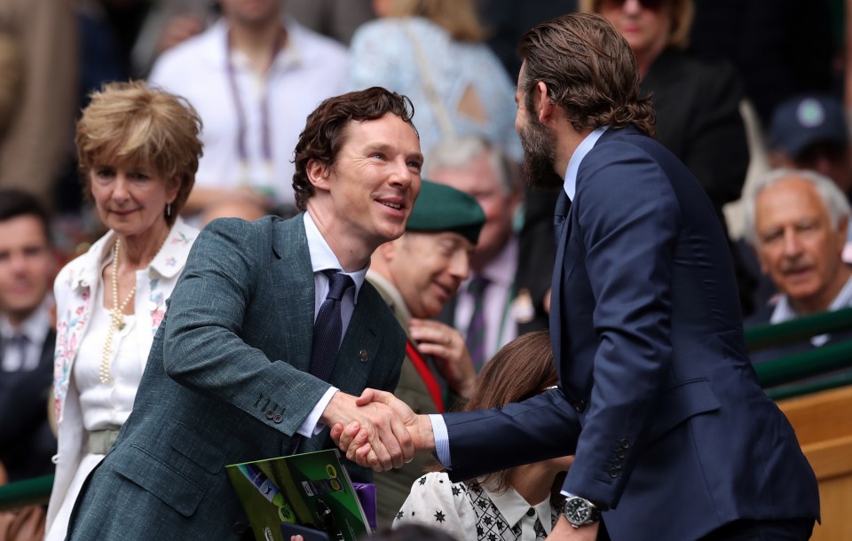  Actor Benedict Cumberbatch shakes hands with actor Bradley Cooper as they arrive in the Royal Box