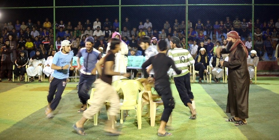  Some of the participants take part in a game of musical chairs, with one of them even wearing a Celtic football shirt