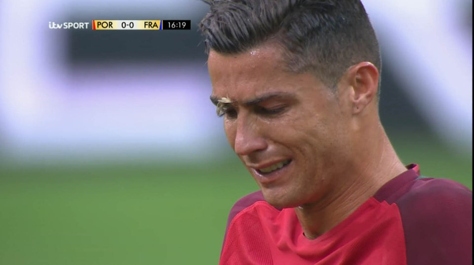 Cristiano Ronaldo agonises over his injury after a clash with Dimitri Payet