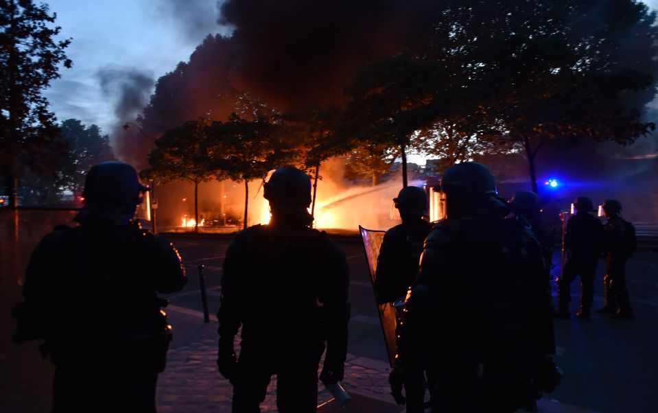  French riot police stand as water cannon is used