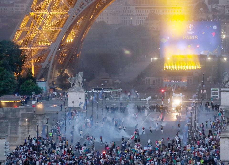  Riot police and hooligans clash under the iconic Eiffel Tower