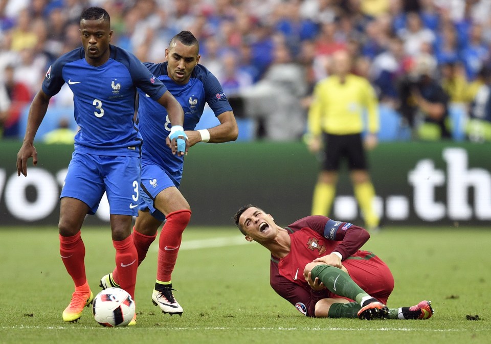  Cristiano Ronaldo feels the pain after Dimitri Payet's strong challenge in Euro 2016 final