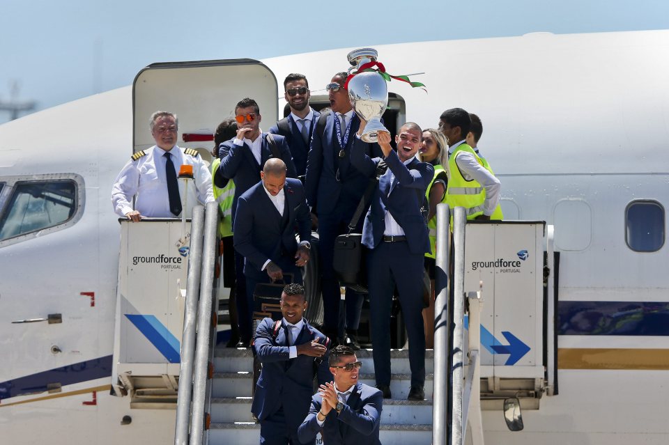  Defender Pepe lifts the cup as the victors leave the plane