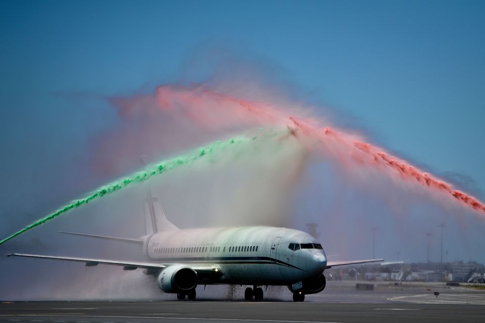  An airport firefighter's unit spray water in the national colours green and red as the victorious Portugal squad arrive back in Lisbon