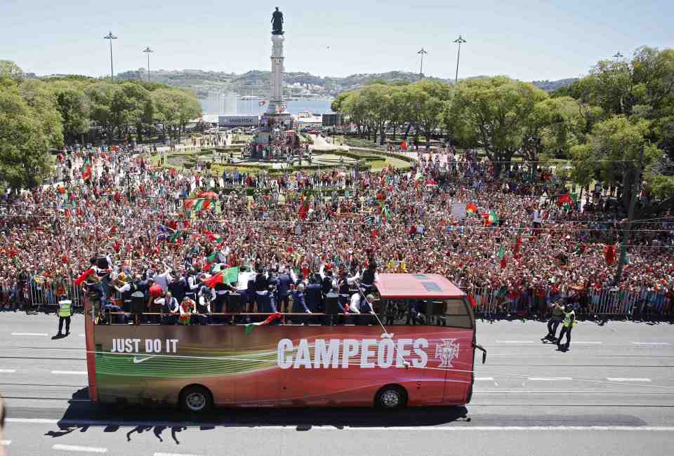  The Portugal players ride back on the open-top bus