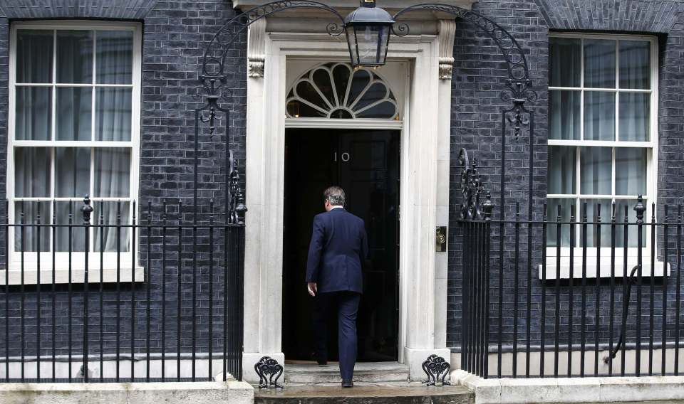  Cameron walks back into No10 after announcing he would leave on Wednesday