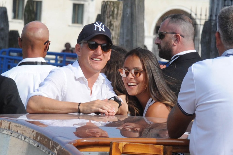  Manchester United star Bastian Schweinsteiger and Ana Ivanovic have a laugh on the Elisa Clara in Venice before their wedding