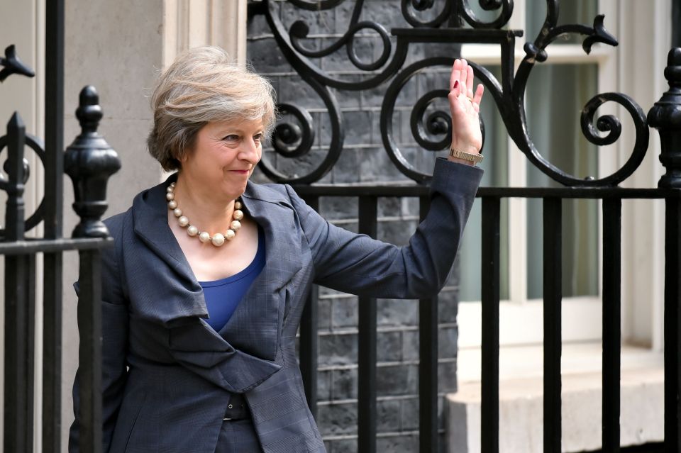  Mrs May waved to the cameras as she spends her last day as Home Secretary