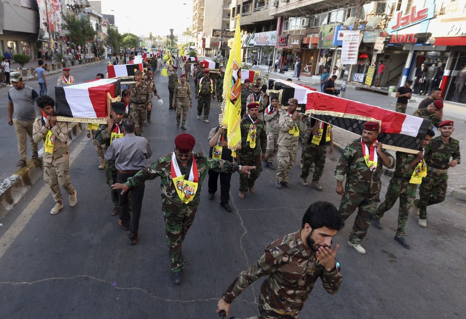  Iraqi flag-draped coffins carried through the streets