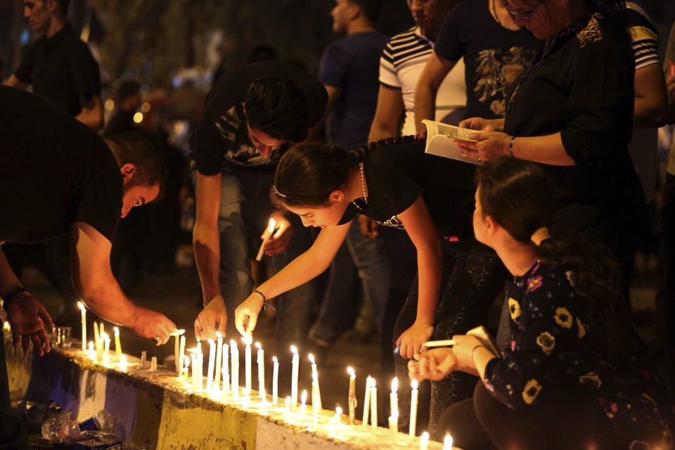  People light candles for the deadly suicide attack which killed nearly 300 people