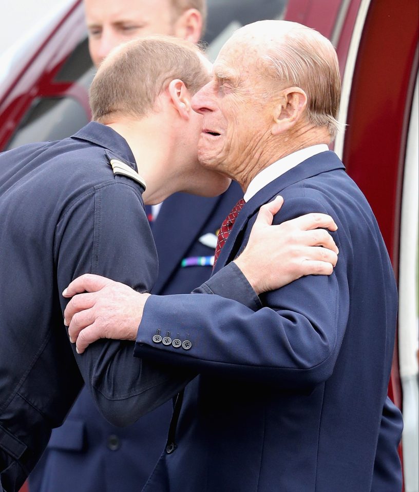 Prince Williams lands a smacker on his granddad Prince Philip at Cambridge Airport