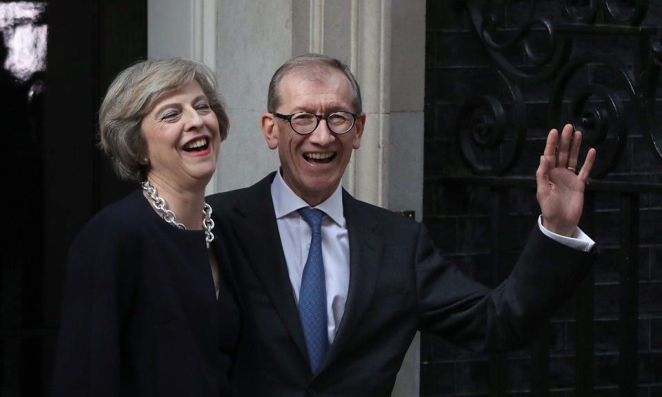 May laughs as she arrives at No10 to take up her new position