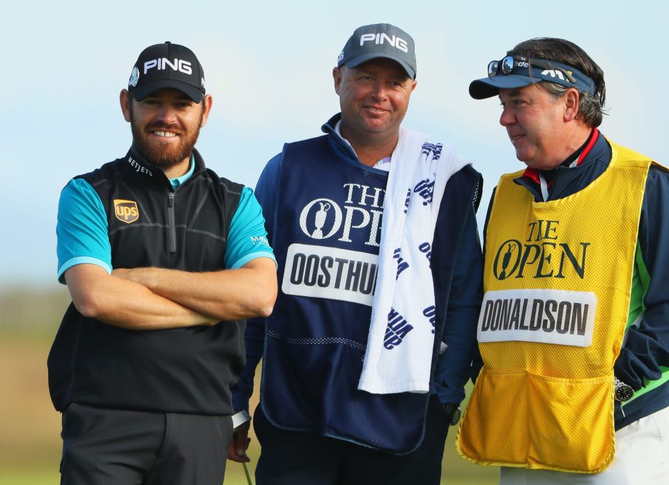  Oosthuizen chats with caddie Greg Hearmon as he reflects on his hole-in-one