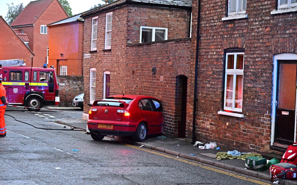  A woman was thrown from her bath and crushed under rubble from her bathroom wall when a speeding driver crashed into her car