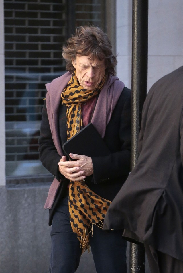  Old-time blues . . . Mick heads for his car in New York