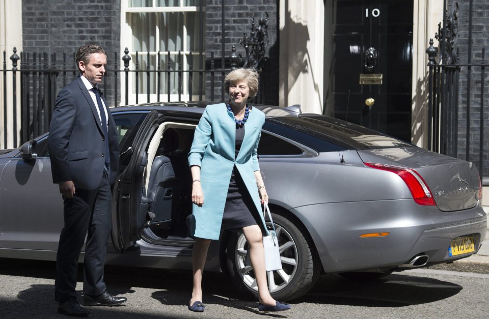  Theresa May pictured getting out of her car this morning before restarting the business of appointing her Cabinet