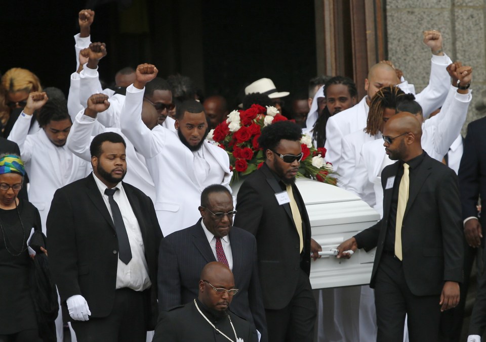  His coffin, which was festooned with flowers, was carried by family members and friends who were dressed in white suits - mourners rose their fists aloft and shouted "Unite" at the end of the ceremony