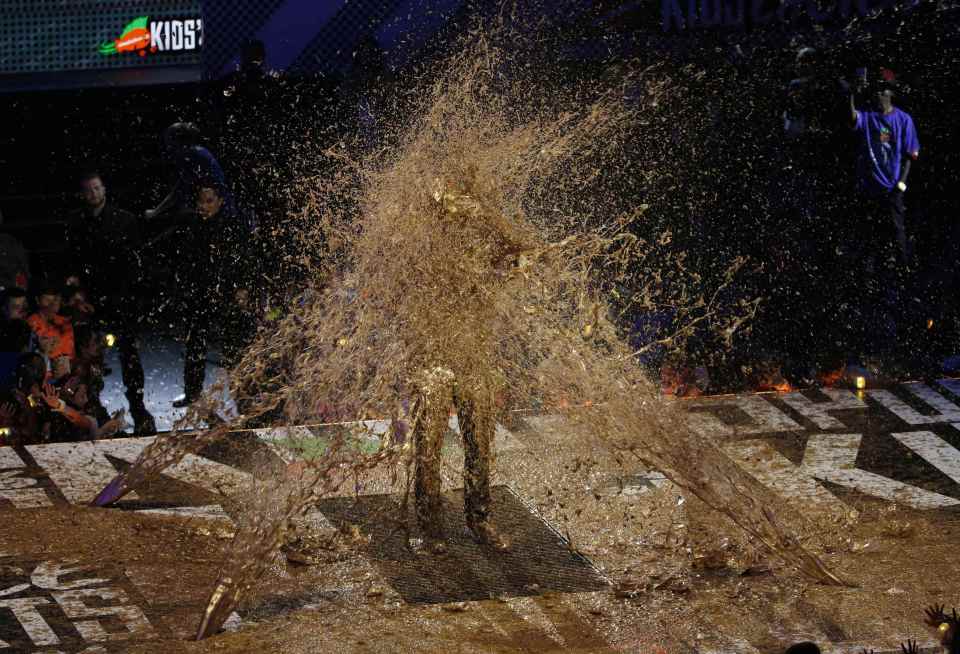 LA Lakers legend player Kobe Bryant is slimed as he accepts the "Legend" award at the Kids Choice Sport 2016 awards in Los Angeles