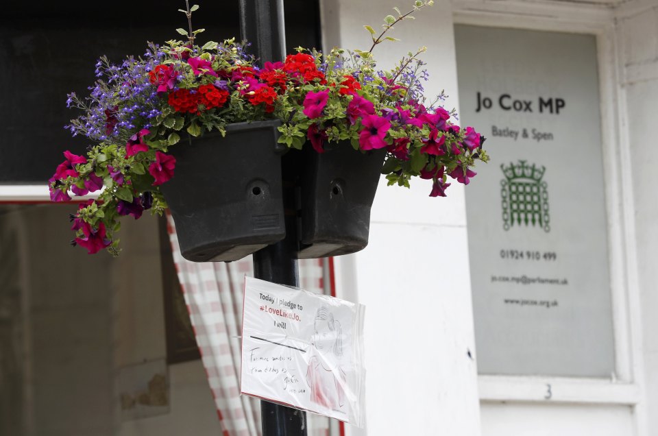 A sign hangs outside Member of Parliament Jo Cox's office in Batley with the hashtag #LoveLikeJo